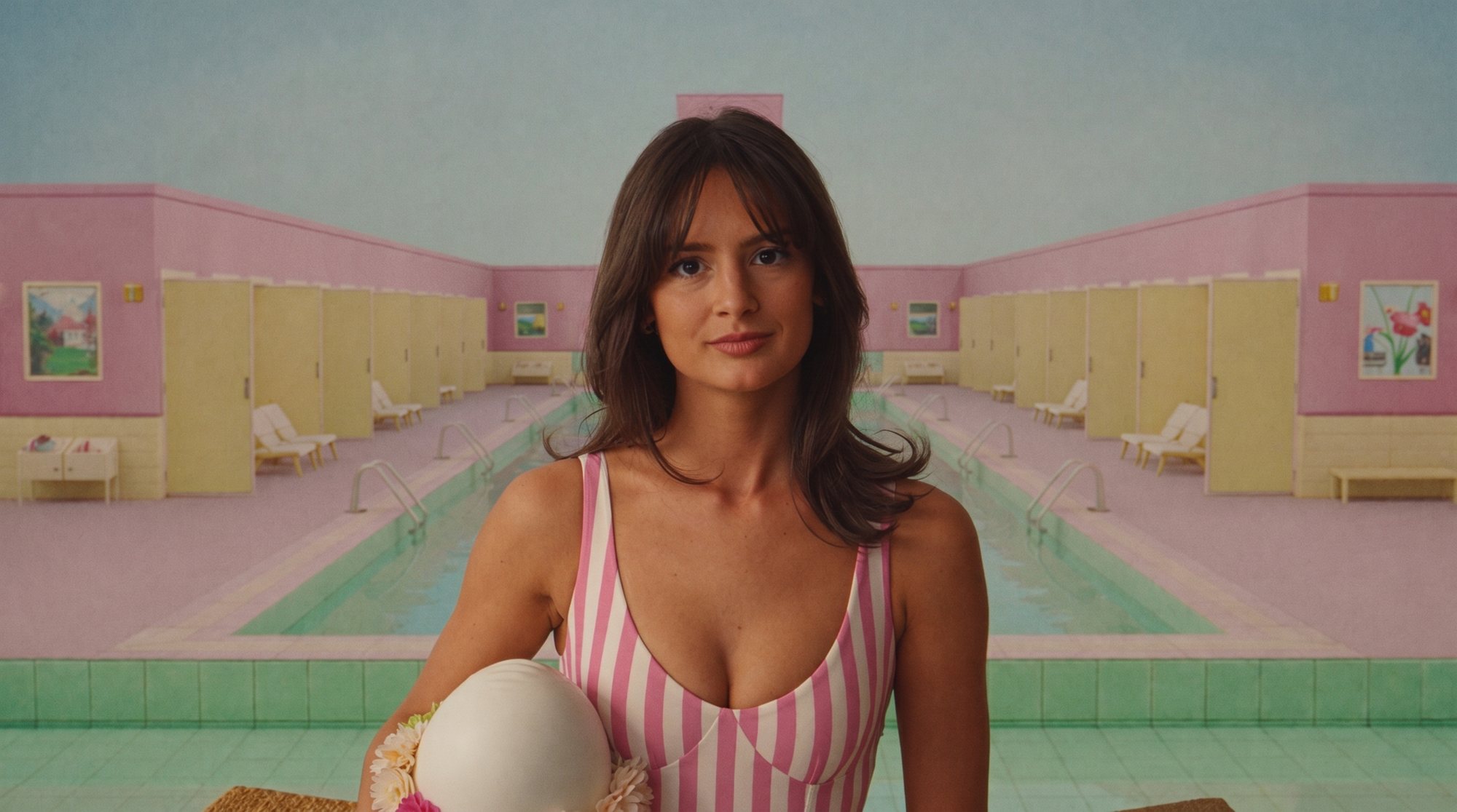 Carla in a striped swimsuit holding a white swim cap at a symmetrical pink and yellow lido.