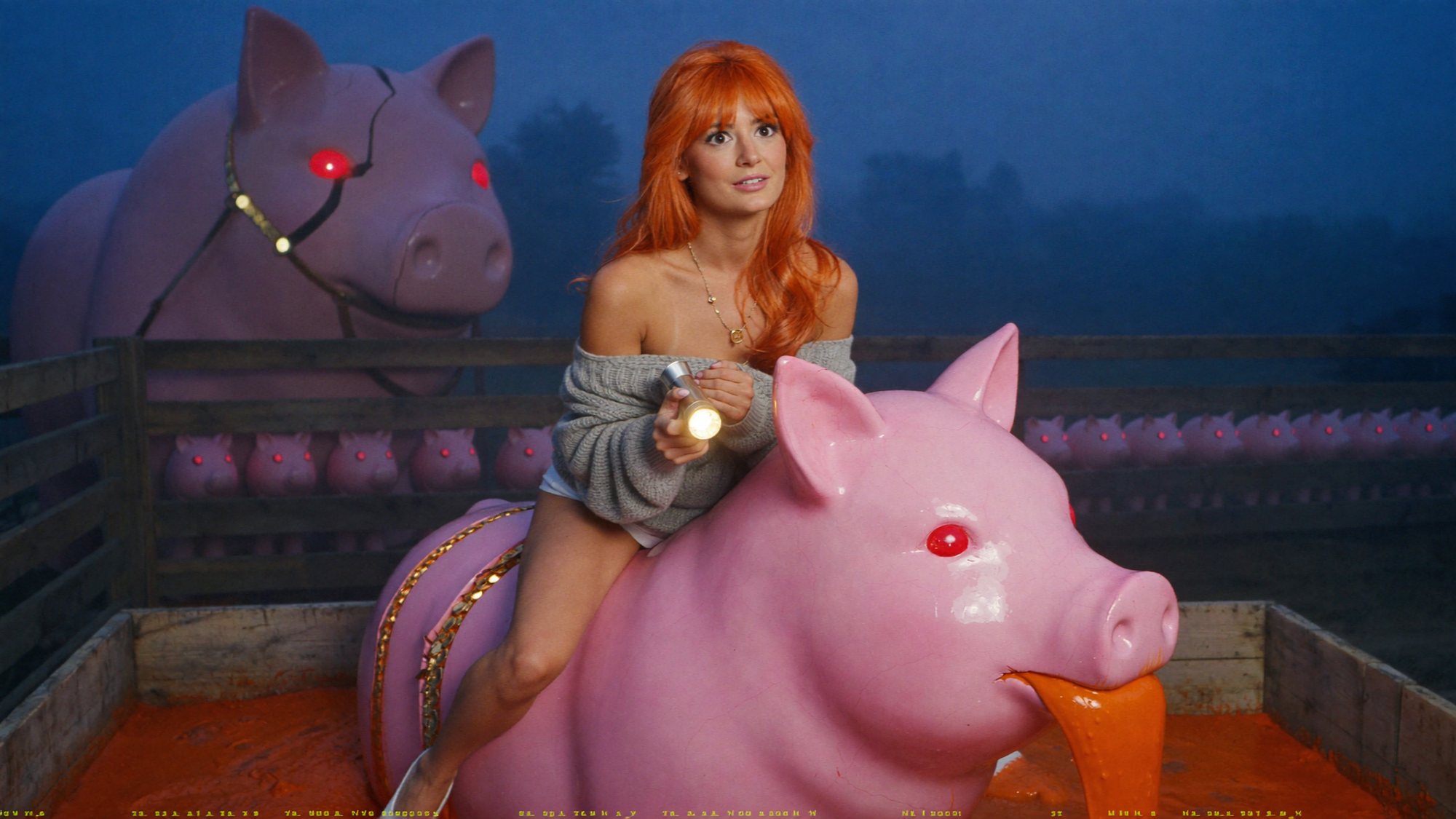 Orange-haired Carla in a sweater on a pink pig with glowing red eyes in a foggy night yard.