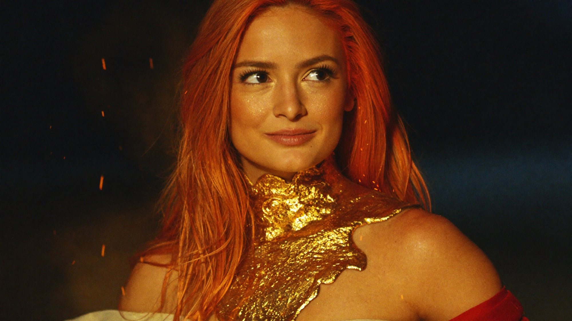 Orange-haired Carla wearing a collar of liquid gold, sparks drifting in the dark.