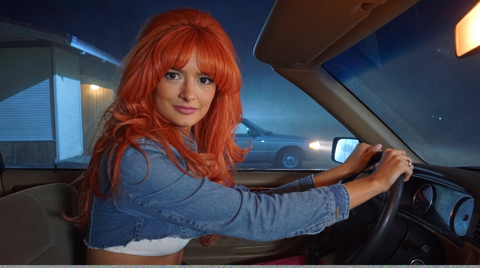 Orange-haired Carla in a denim jacket gripping the wheel of a station wagon on a foggy night.
